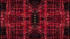 Close-up abstract pattern of intertwined colorful light beams on a black background