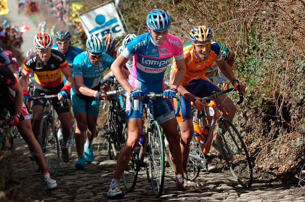 Italian Alessandro Ballan (C-Lampre) remounts his bike after a fall next to Graeme Brown (Rabobank) (R) during the 90th Tour of Flanders in 2006.