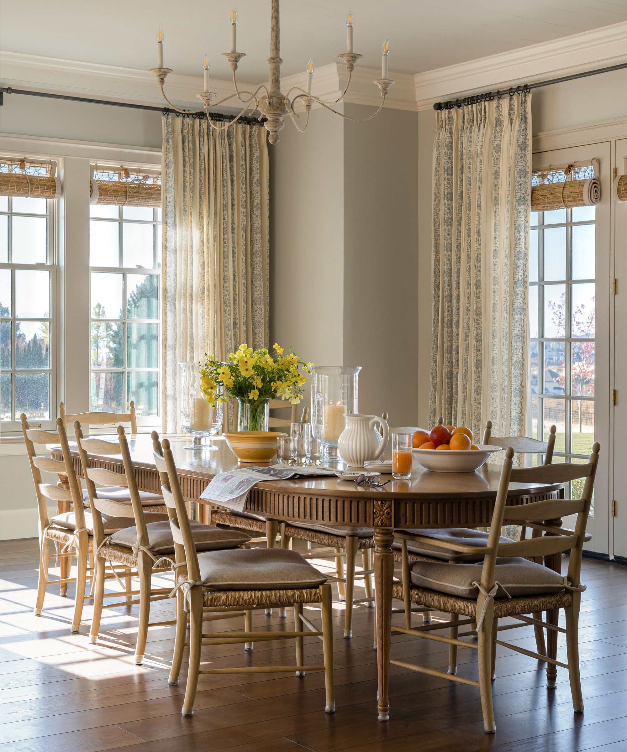dining room with oval table and sheer drapes