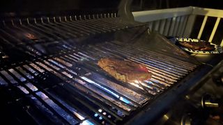 Meater in steak on grill