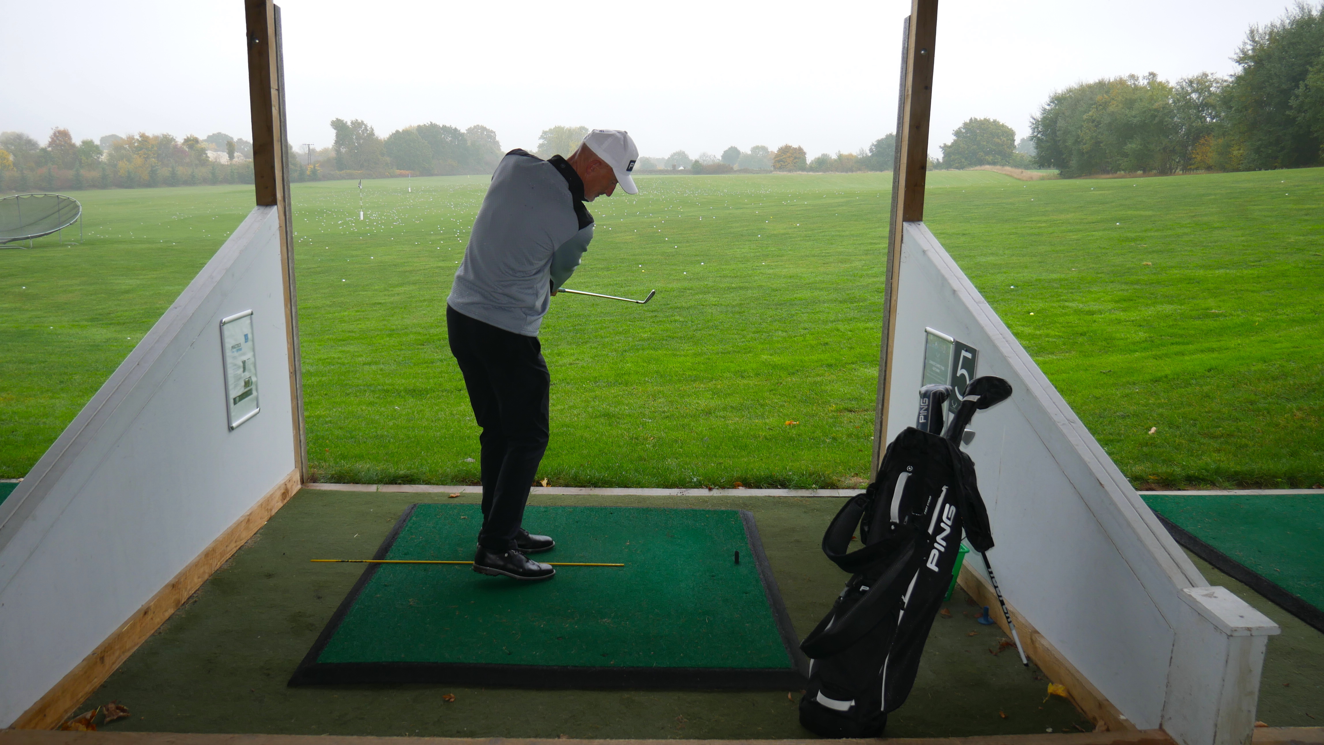 A golfer practices on golf range