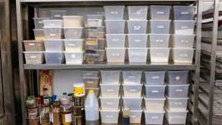 Plastic food containers stacked in a pantry