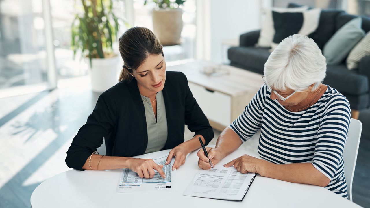 An insurance agent and her older female client.