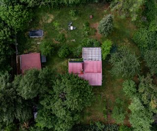 ariel view of land with small house on plot