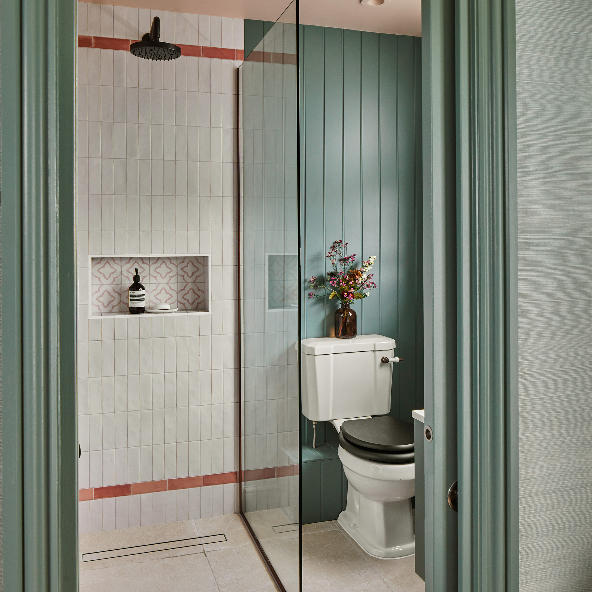 Wet room with panelled walls and tiles