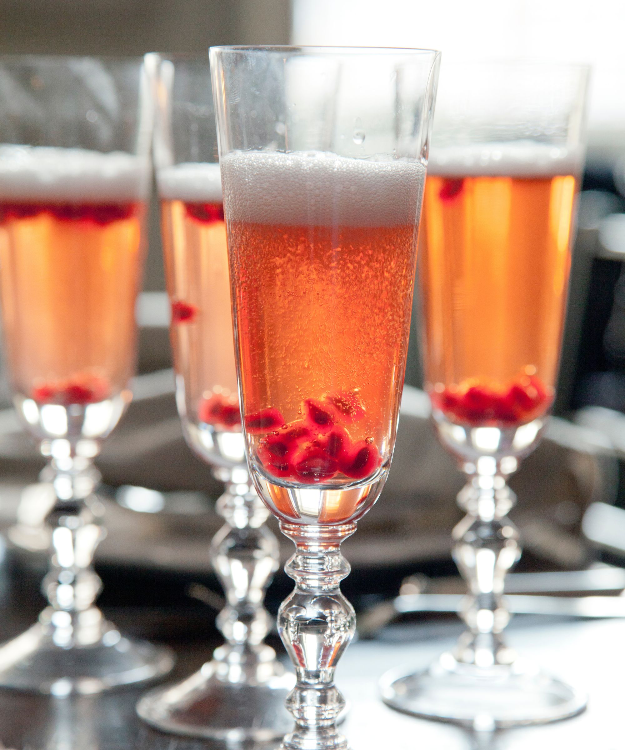 Christmas cocktails in flutes with pomegranate seeds