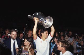 Marco van Basten celebrates with the European Cup after AC Milan's win over Benfica in the final in 1990.