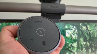 A close up of the control dial of the BenQ ScreenBar Halo monitor light bar with the bar in the background