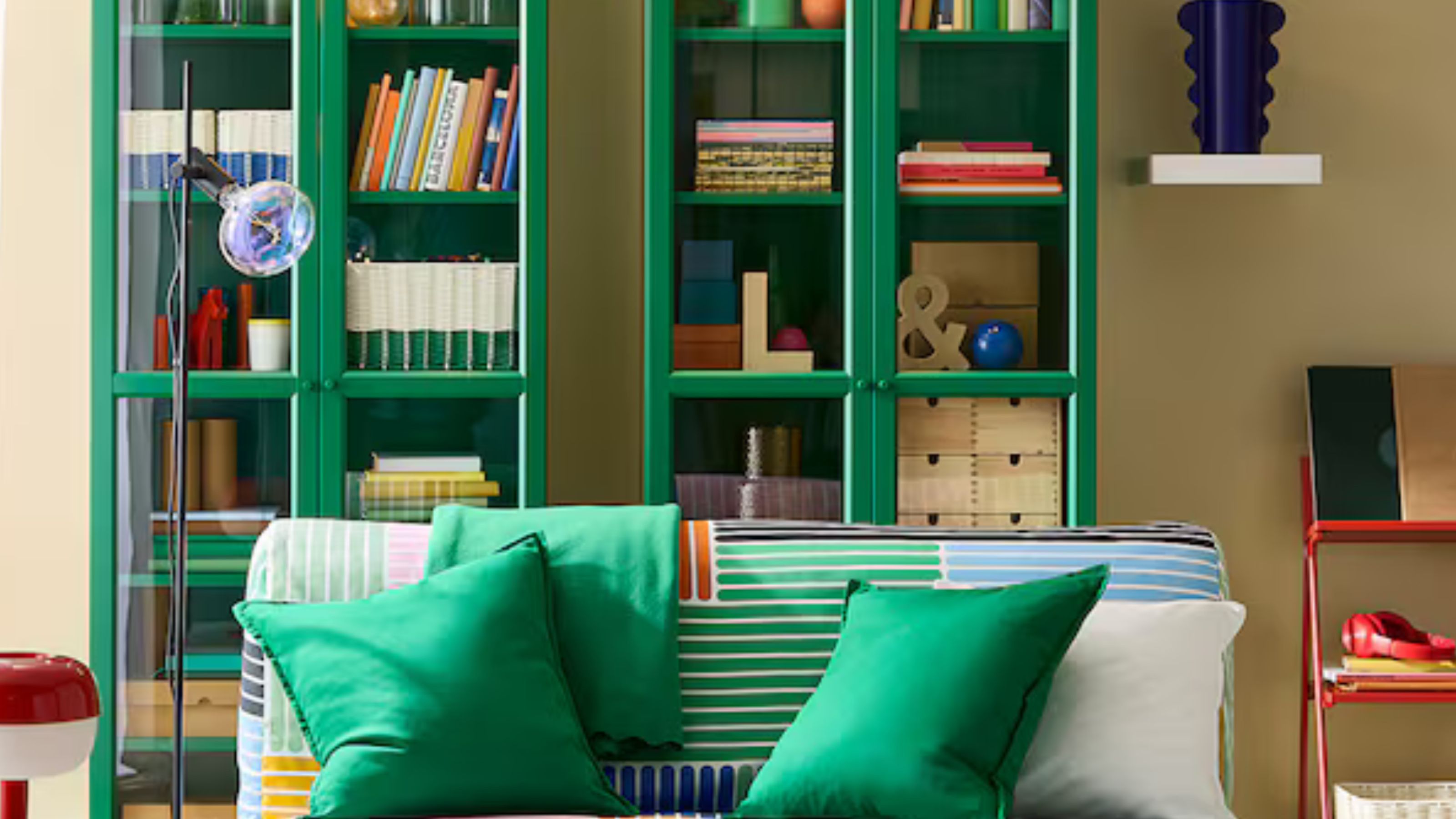 IKEA BILLY bookcase in green in butter yellow living room and geometric sofa.
