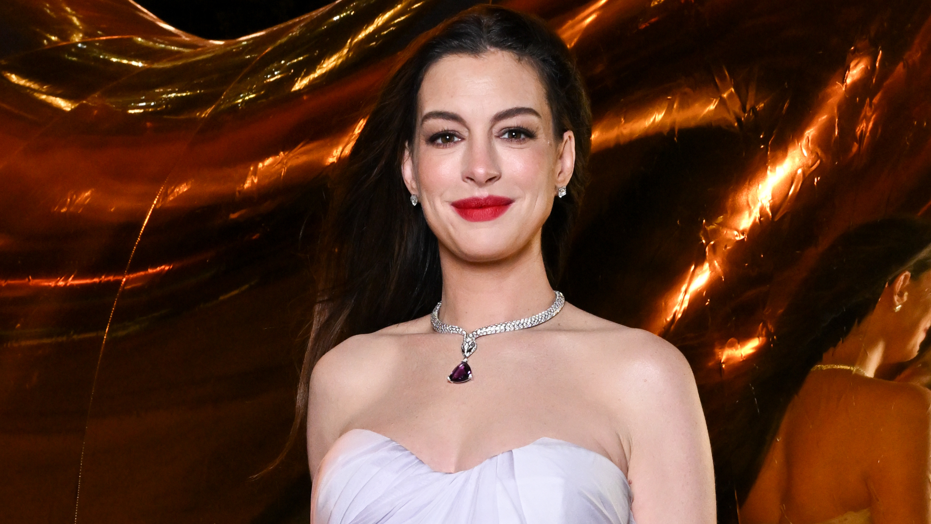 Anne Hathaway brought a little purple purse from Bulgari to a New York Fashion Week event