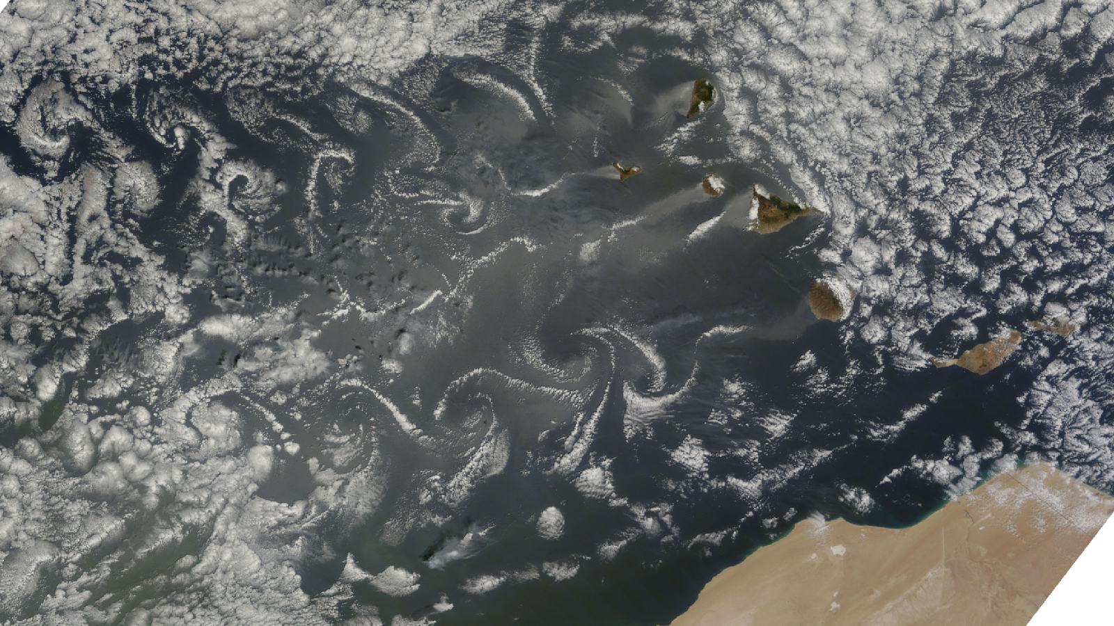 Satellite image of cloud vortices swirling behind islands in the Atlantic Ocean