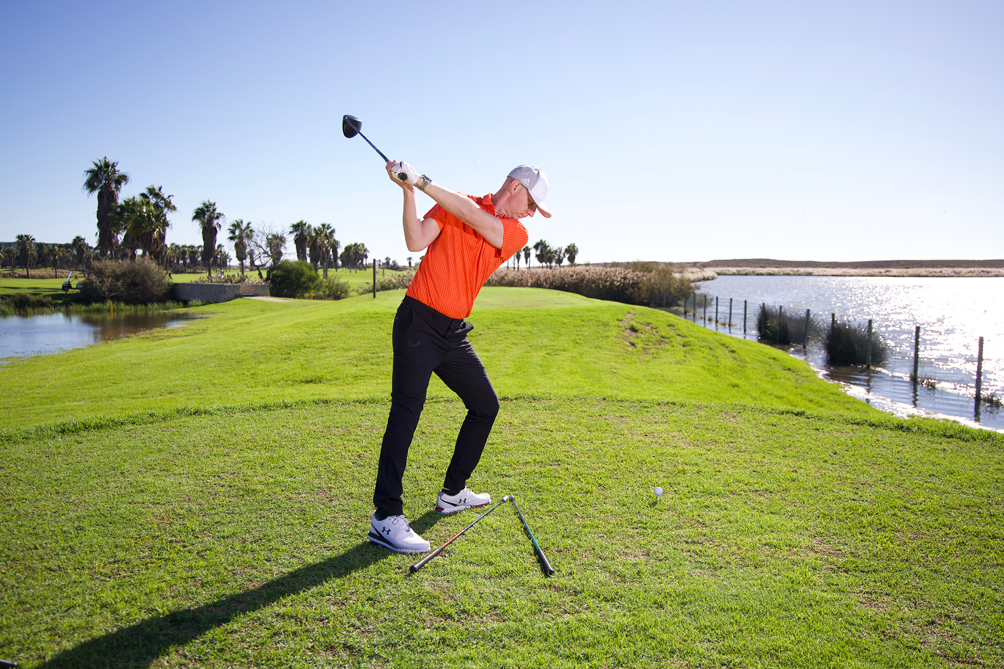 Ged Walters demonstrating the bowler drill, with his trail foot pulled back, producing the path that promotes a draw or straight flight and removing the fault around the path that causes a slice