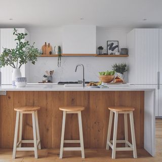 Kitchen with white cupboards and wooden island