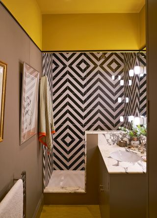 Black and white bathroom tiles in a shower enclosure