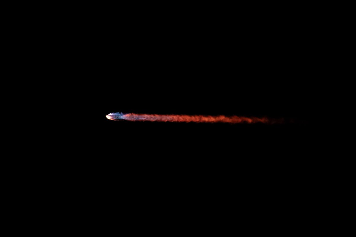 close-up of a rocket streaking to space in night