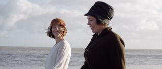 Rose Gooding (Jessie Buckley) and Edith Swan (Olivia Colman) side by side on the beach in Wicked Little Letters.
