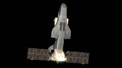 The new photo of Shenlong in space. It looks like a Space Shuttle with solar panels stuck on its bottom end