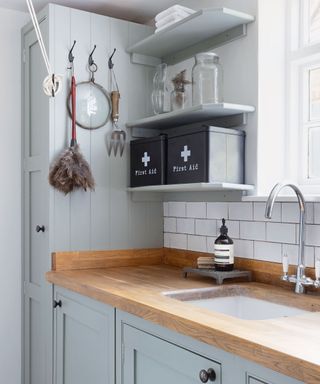Utility with wooden worktop and open shelving in Georgian home
