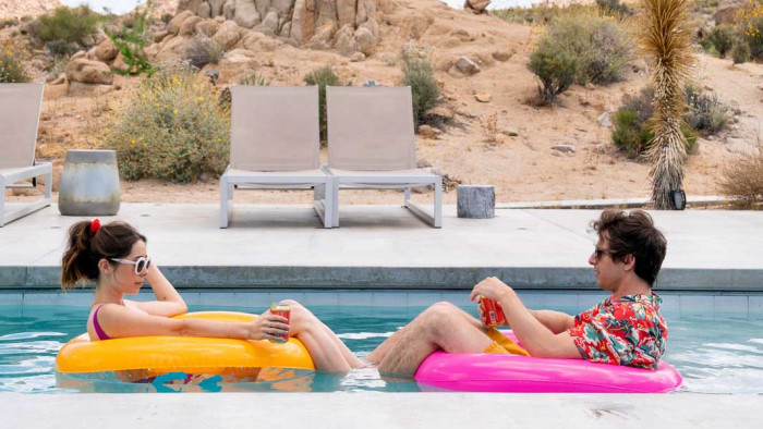 Andy Samberg and Crisitin Milioti sat in a pool