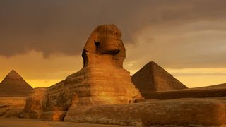 Here we see the sphinx in front of the Great Pyramid at Giza in Egypt.