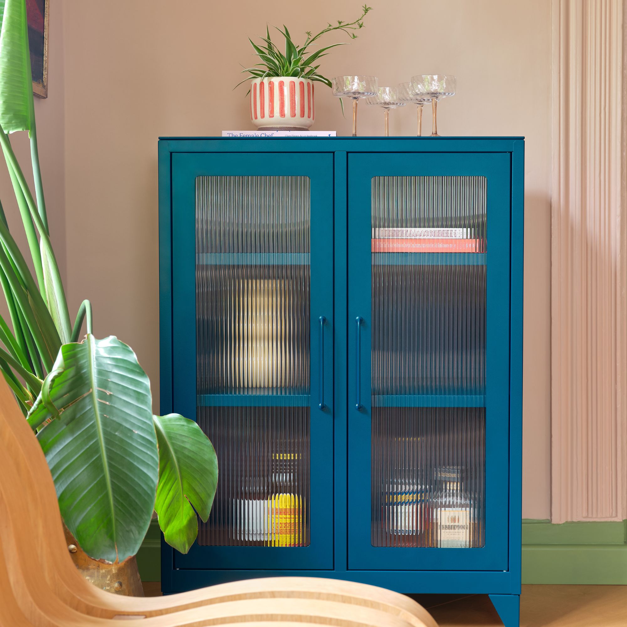 A blue storage cabinet with reeded glass