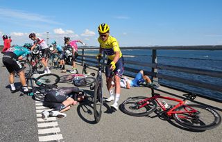 QuickStep Alpha Vinyl Teams Belgian rider Yves Lampaert wearing the overall leaders yellow jersey mounts his bicycle after suffering a crash with Totalenergies teams French rider Anthony Turgis EF EducationEasypost teams Portuguese rider Ruben Antonio Almeida Guerreiro and BB HotelsKTM teams Italian rider Luca Mozzato on a bridge in the final kilometers of the 2nd stage of the 109th edition of the Tour de France cycling race 2022 km between Roskilde and Nyborg in Denmark on July 2 2022 Photo by Etienne GARNIER POOL AFP Photo by ETIENNE GARNIERPOOLAFP via Getty Images