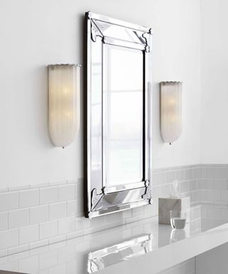 Art Deco style bathroom wall lights on either side of a mirror