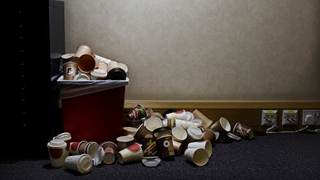 A waste bin in an office, overflowing with coffee cups during a period of developer crunch.