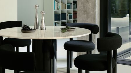 black dining chairs around a white round table