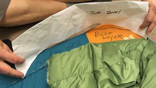 A prototype Zenbivy bed, showing cut out pieces of fabric and paper labelled and held in place.