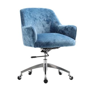 A blue velvet chair with large armrests