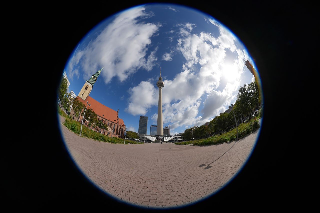 Circular fisheye view of Berlin&rsquo;s Fernsehturm TV tower and St. Mary&rsquo;s Church, surrounded by a black frame.