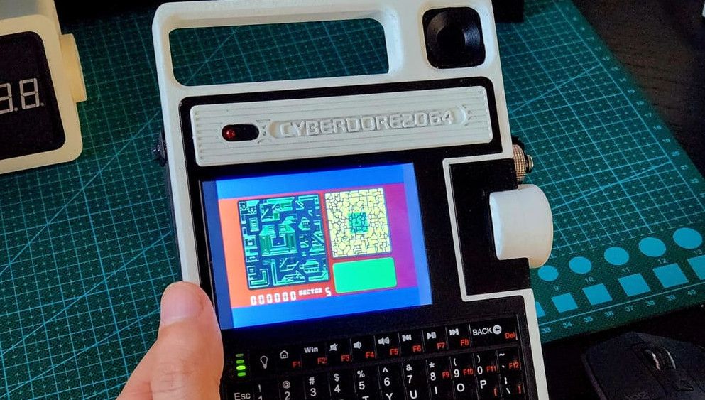 photo of Cyberdore 2064 Cyberdeck features an oversized scroll wheel, handle, OLED display, and Raspberry Pi Zero image