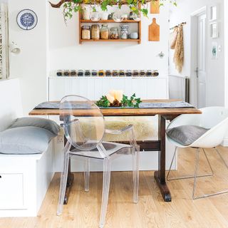 white kitchen booth with spice racks and Perspex chair