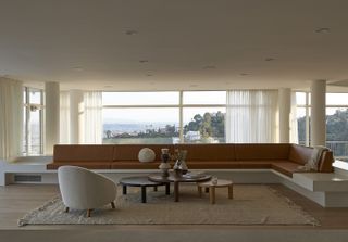 mustard sofa and white interior against los angeles views at Oceanus House by Pierre de Angelis