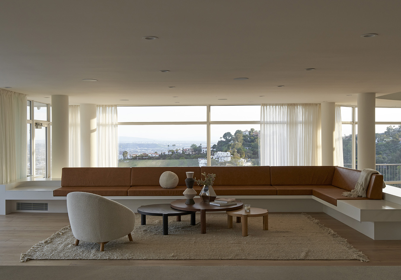 mustard sofa and white interior against los angeles views at Oceanus House by Pierre de Angelis