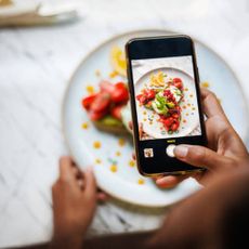 Someone taking a photo of a plate of food