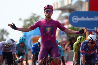 Team Lidl-Trek's Italian rider Jonathan Milan (C) celebrates as he crosses the finish line to win the 11th stage of the 107th Giro d'Italia cycling race, 207km between Foiano di Val Fortore and Franca Villa al Mare, on May 15, 2024. (Photo by Luca Bettini / AFP)