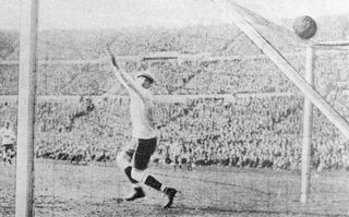 Uruguayan keeper Enrique Ballestrero fails to save a shot from Argentina's Carlos Peucelle to equalising the score at 2-2 in the final of the first world Cup competition in Montevideo, Uruguay. Uruguay eventually won 4-2.