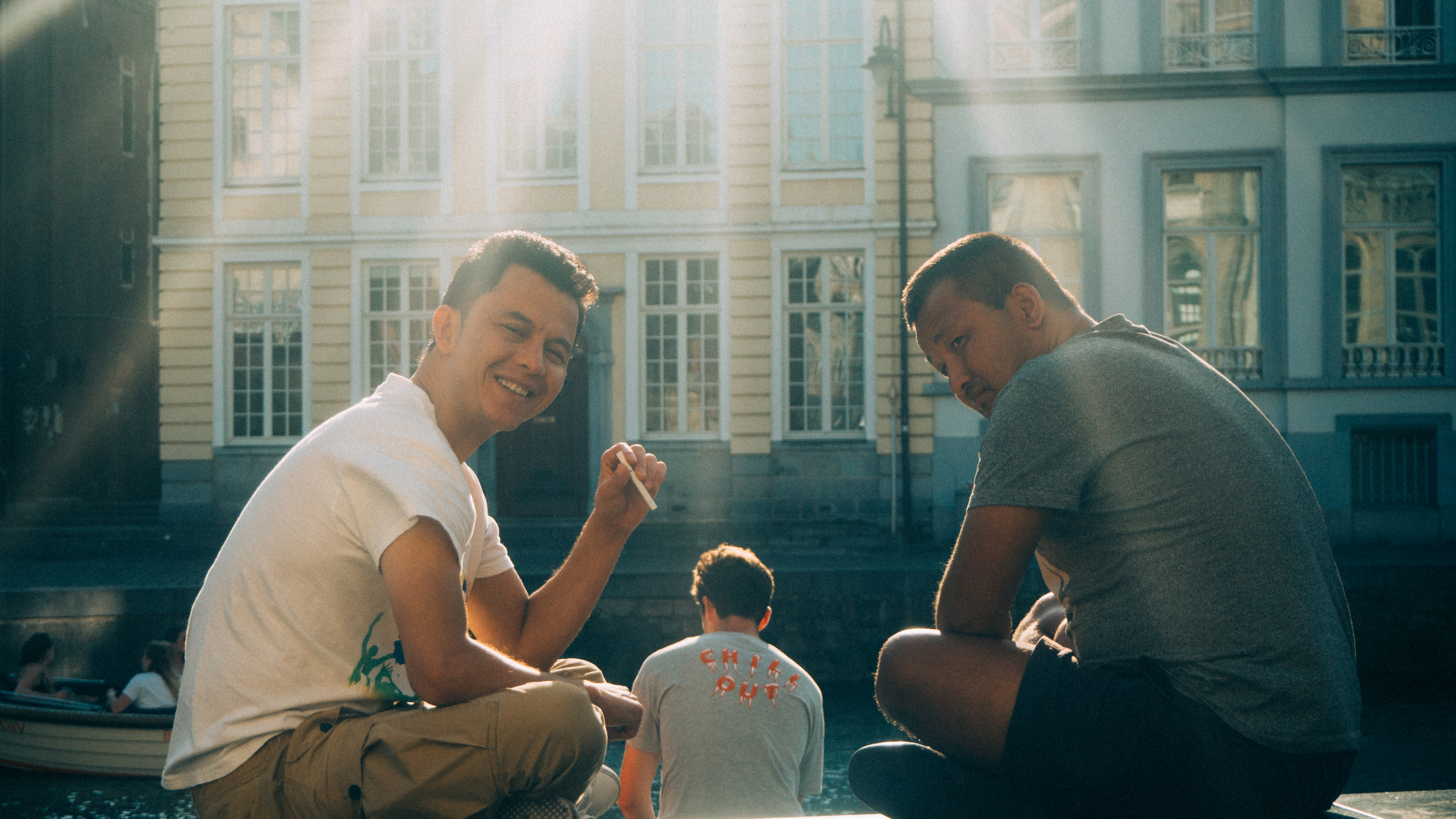 An image of two smiling men sitting on a bench, Olympus EM-5 Mark II sample images