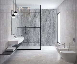 Black framed shower screen in a marble-effect tiled shower room