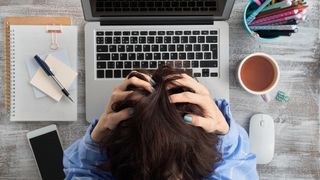 Woman at laptop suffering from burnout