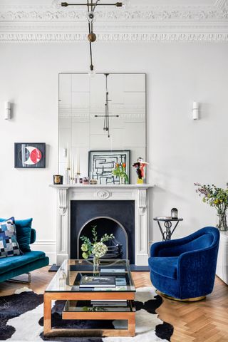 White living room with large mirror over fireplace
