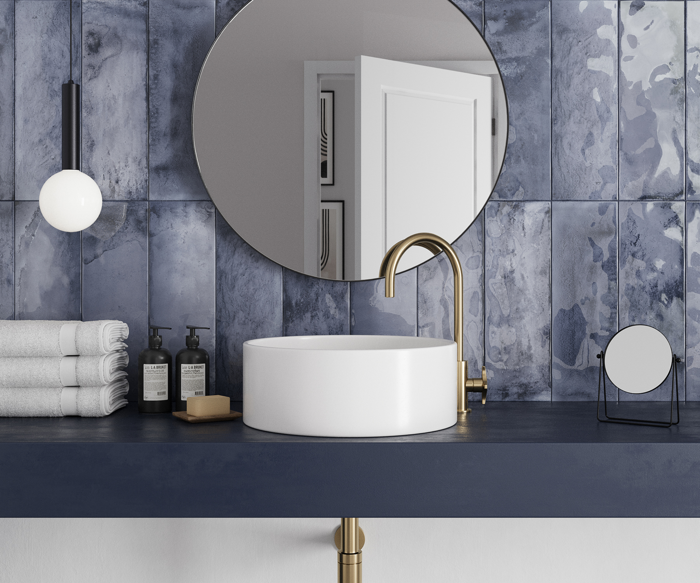bathroom with blue wall tiles and blue vanity shelf with white sink