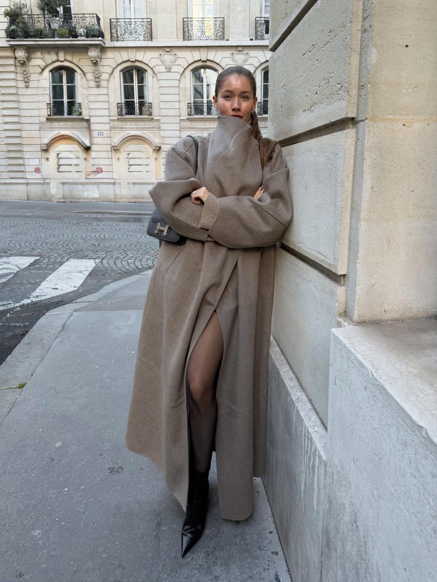 Woman wearing funnel neck coat.