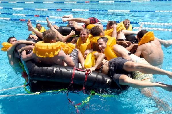 Last one in has to buy a round: Fly V Australia's riders and staff scramble into the life raft.