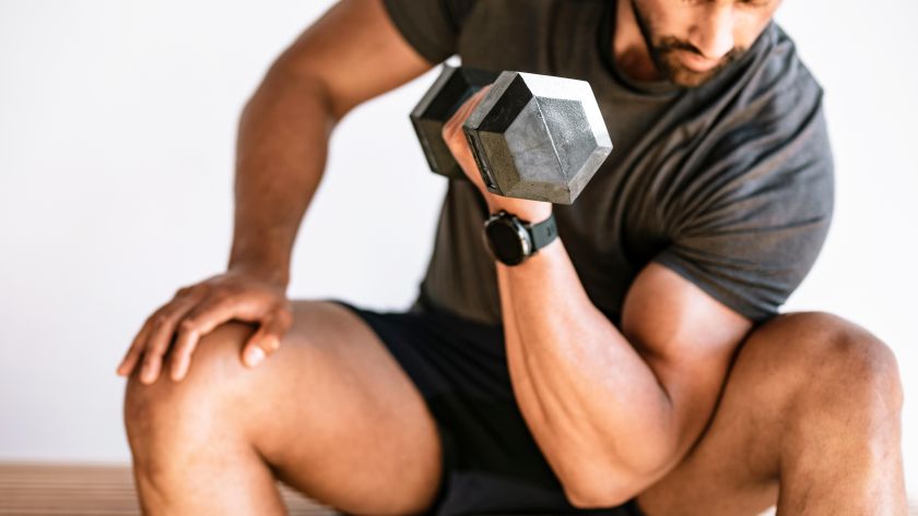 a man holding a dumbbell