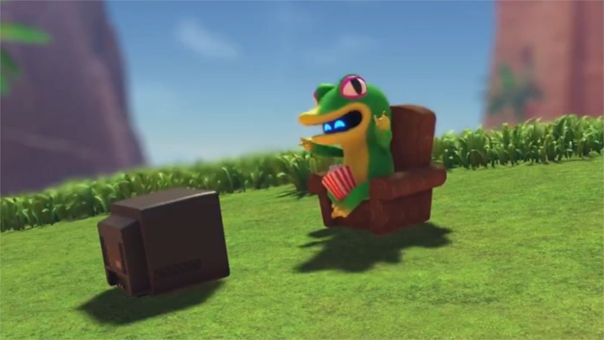 A little bot in a Gex costume adorably waving his arms as he watches TV with a bucket of popcorn on his lap. I hope nobody knocks it over