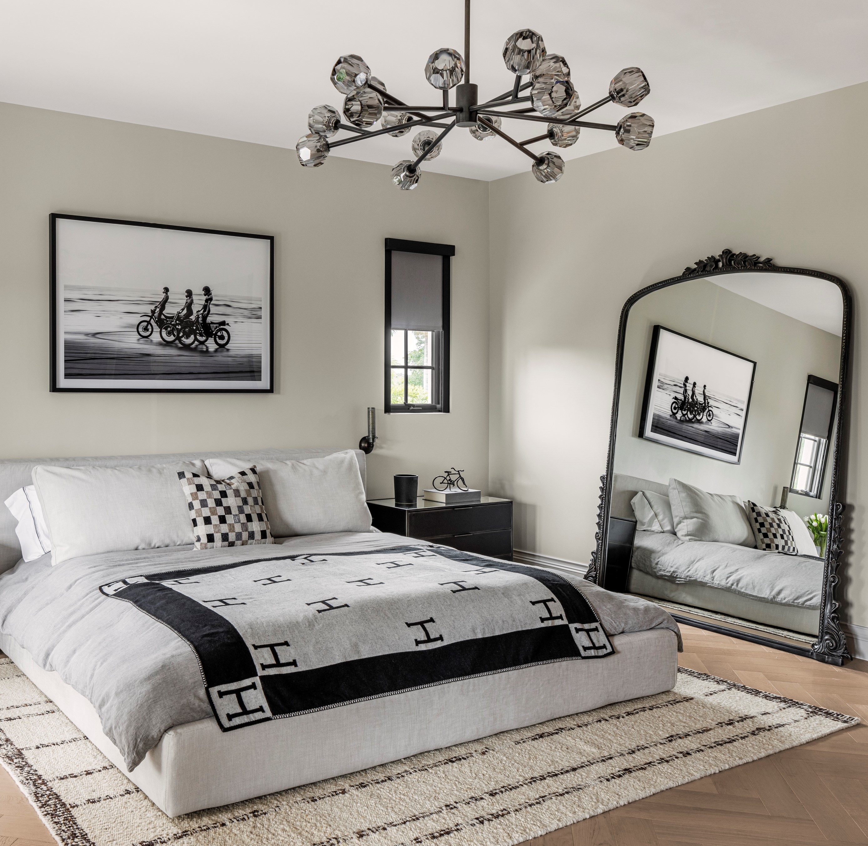 A bedroom with a vintage mirror