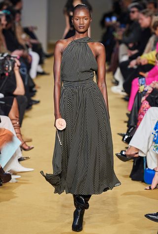 a photo of a model wearing a polka dot dress with black boots at Philosophy by Lorenzo Serafini fall 2023 runway show